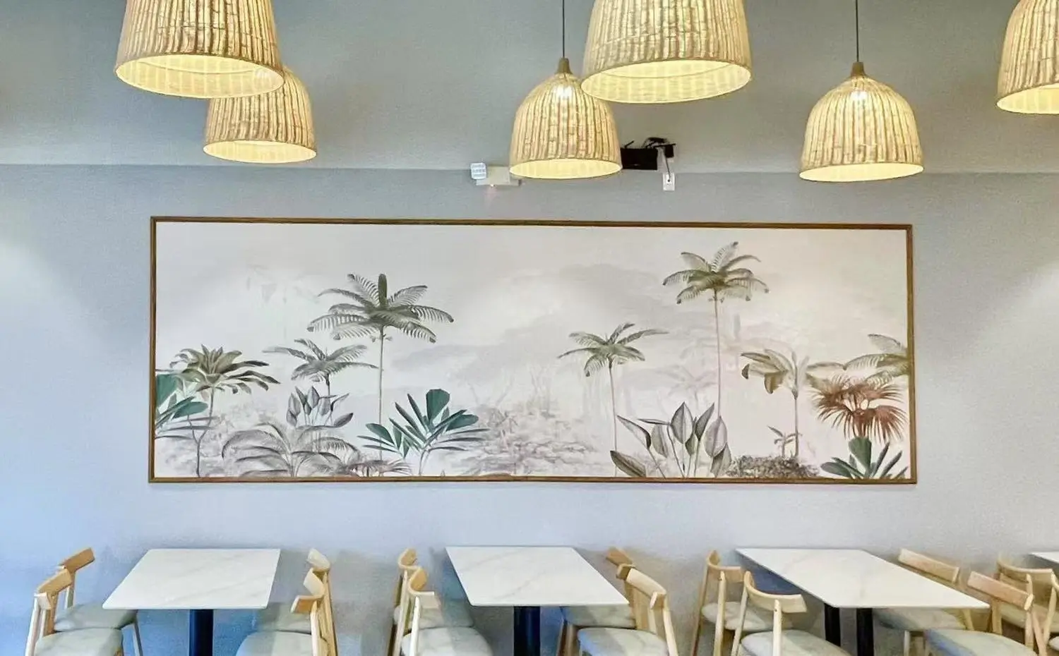 Vegee-Green-Chinese-Restaurant-Restaurant-Interior-Missouri-City Cozy dining area with tropical art and woven pendant lights at Vegee Green,a Chinese Restaurant in Missouri City.